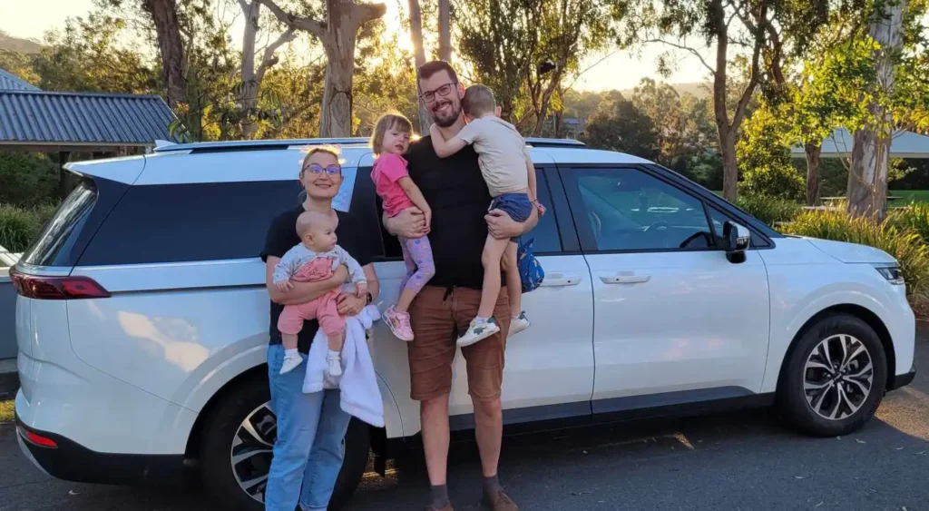 Family in front of Kia